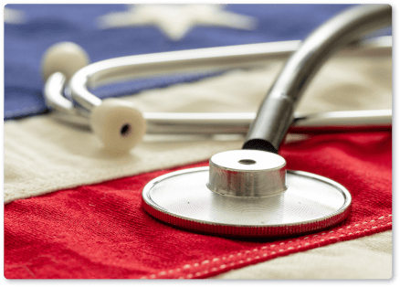 Medical stethoscope on a red and beige cloth, symbolizing healthcare policies.